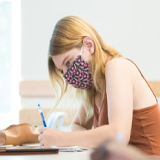 Student in class masked and socially distant
