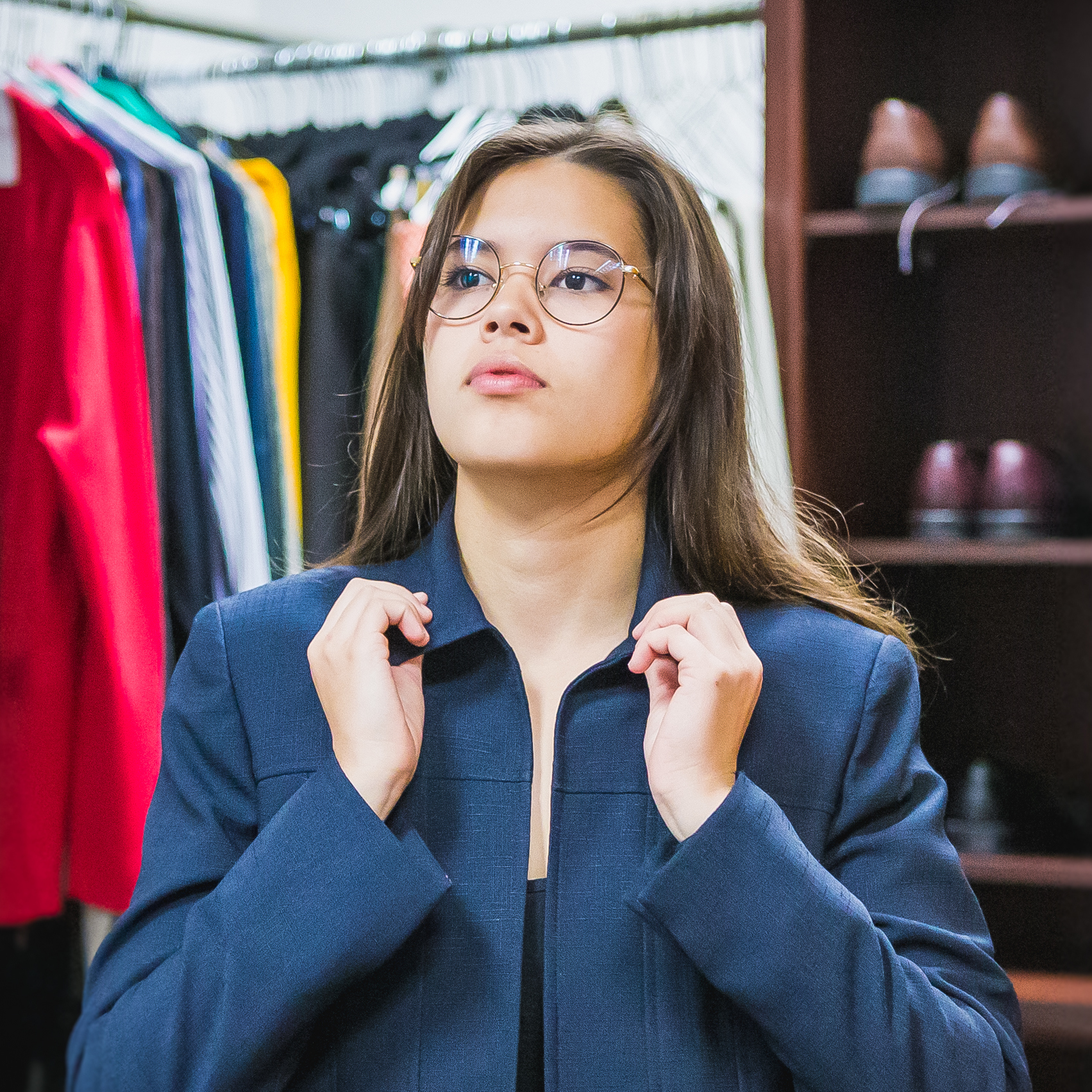 Student tries on blazer in UNC's Professional Attire Closet. 